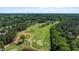 Picture of a verdant green golf course with a lake surrounded by tall trees and homes at 1132 Heritage Knoll Dr, Wake Forest, NC 27587