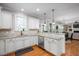 Bright kitchen with white cabinets, stainless steel appliances, and hardwood floors at 1132 Heritage Knoll Dr, Wake Forest, NC 27587