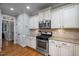 Eat-in kitchen featuring granite countertops, stainless steel appliances, and hardwood floors at 1132 Heritage Knoll Dr, Wake Forest, NC 27587
