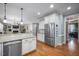 Open kitchen featuring stainless steel appliances, granite countertops, and hardwood floors at 1132 Heritage Knoll Dr, Wake Forest, NC 27587
