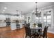 Bright kitchen and dining area featuring stainless appliances, bar seating, and natural light at 1132 Heritage Knoll Dr, Wake Forest, NC 27587