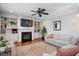 Comfortable living room featuring built-in cabinets, a fireplace, and a ceiling fan at 1132 Heritage Knoll Dr, Wake Forest, NC 27587