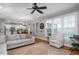 Inviting living room with hardwood floors, large windows, and views of the kitchen at 1132 Heritage Knoll Dr, Wake Forest, NC 27587
