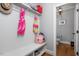 Mudroom with storage bench and coat hooks, next to bathroom at 1132 Heritage Knoll Dr, Wake Forest, NC 27587