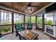 Screened patio with ceiling fan, fireplace, seating, and views of the lush backyard at 1132 Heritage Knoll Dr, Wake Forest, NC 27587