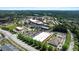 Aerial view of a shopping center with ample parking surrounded by trees and roadways at 1132 Heritage Knoll Dr, Wake Forest, NC 27587