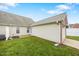 Exterior view of backyard with vinyl siding and lush green lawn at 11340 Involute Pl # 100, Raleigh, NC 27617