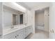Bathroom featuring double sinks, white cabinets, and a large mirror at 11340 Involute Pl # 100, Raleigh, NC 27617