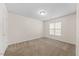 Bedroom showcasing a neutral carpet, a window, and white trim at 11340 Involute Pl # 100, Raleigh, NC 27617