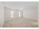 Expansive bedroom with neutral carpeting and two windows for ample light at 11340 Involute Pl # 100, Raleigh, NC 27617