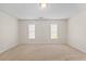 Bright bedroom with neutral carpet and two windows allowing natural light at 11340 Involute Pl # 100, Raleigh, NC 27617