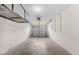 Spacious garage with overhead storage racks, concrete floor, and white walls at 11340 Involute Pl # 100, Raleigh, NC 27617