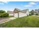 Detached garage surrounded by a green lawn and vinyl siding at 11340 Involute Pl # 100, Raleigh, NC 27617