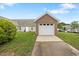 View of the detached two-car garage with a paved driveway at 11340 Involute Pl # 100, Raleigh, NC 27617