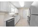 Bright and modern kitchen featuring stainless steel appliances, white cabinets and tile flooring at 11340 Involute Pl # 100, Raleigh, NC 27617