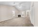 Open-concept living room with vaulted ceiling, fireplace, and access to kitchen and dining at 11340 Involute Pl # 100, Raleigh, NC 27617