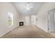 Bright living room with fireplace, neutral carpet, ceiling fan, and a view into other rooms at 11340 Involute Pl # 100, Raleigh, NC 27617