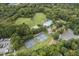 Aerial view showcasing the pool, tennis courts, park, and wooded surroundings of the community at 115 Nuttree Way, Durham, NC 27713
