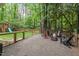 Landscaped backyard with fence, patio, fire pit, and playset at 115 Nuttree Way, Durham, NC 27713