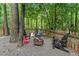 Cozy backyard space featuring a charming firepit surrounded by Adirondack chairs at 115 Nuttree Way, Durham, NC 27713