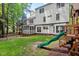 View of the home's backyard with a playset and screened porch at 115 Nuttree Way, Durham, NC 27713