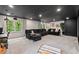 Basement with a home theatre set up, home office, wet bar, and comfy seating at 115 Nuttree Way, Durham, NC 27713