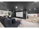 Basement features a dark ceiling, projector screen, wet bar, and sectional couch at 115 Nuttree Way, Durham, NC 27713