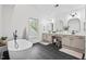 Bright bathroom with white vanity, a standalone tub, and modern fixtures at 115 Nuttree Way, Durham, NC 27713