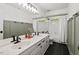 Bright bathroom features dual sinks, modern fixtures, and a shower-tub combination at 115 Nuttree Way, Durham, NC 27713