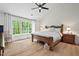 Bedroom features a large window with wooden floors, trim, and a bed at 115 Nuttree Way, Durham, NC 27713