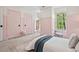 Charming bedroom boasts unique pink trim, soft natural light, and ample space at 115 Nuttree Way, Durham, NC 27713