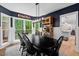 Stylish dining room featuring navy walls, hardwood floors and backyard views at 115 Nuttree Way, Durham, NC 27713
