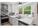 Updated kitchen with stainless steel appliances and ample counter space overlooking the backyard at 115 Nuttree Way, Durham, NC 27713