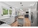 Modern kitchen with white cabinetry, stainless steel appliances, and an open layout at 115 Nuttree Way, Durham, NC 27713