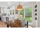 Bright kitchen nook features a rustic table, large window and hanging woven light fixture at 115 Nuttree Way, Durham, NC 27713