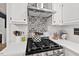 Modern kitchen with updated appliances and black and white backsplash with ample counter space at 115 Nuttree Way, Durham, NC 27713