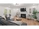 Cozy living room with a fireplace, ample seating, and an open layout at 115 Nuttree Way, Durham, NC 27713