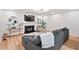 Cozy living room features a modern fireplace, ample seating, and plenty of natural light at 115 Nuttree Way, Durham, NC 27713