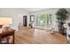 Spacious living area with hardwood floors and large windows with a cozy rocking chair at 115 Nuttree Way, Durham, NC 27713