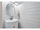 Charming powder room features light blue shiplap walls and a stylish vanity at 115 Nuttree Way, Durham, NC 27713