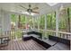 Enjoy the screened porch with modern outdoor seating and a backyard view of the play area at 115 Nuttree Way, Durham, NC 27713