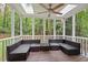 Relaxing screened porch with modern outdoor seating, ceiling fan and a beautiful view of the wooded backyard at 115 Nuttree Way, Durham, NC 27713