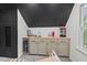 Wet bar in basement featuring light cabinets, wooden countertops, and a small window at 115 Nuttree Way, Durham, NC 27713