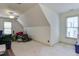 Unfinished attic space with carpet, white walls, and a ceiling fan at 119 Marykirk Pl, Garner, NC 27529