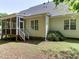 View of the house with screened-in porch and stairs leading to the backyard at 119 Marykirk Pl, Garner, NC 27529