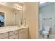 Bathroom with double sinks, neutral walls, and a view into the toilet/shower room at 119 Marykirk Pl, Garner, NC 27529