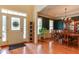Traditional dining room with hardwood floors, wainscoting, decorative chandelier, and large windows at 119 Marykirk Pl, Garner, NC 27529