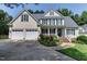 Charming two-story home with well-manicured lawn, colorful flowerbeds, and a three car attached garage at 119 Marykirk Pl, Garner, NC 27529