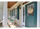 Inviting front porch featuring rocking chairs, a decorative door, and natural lighting at 119 Marykirk Pl, Garner, NC 27529