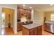 Kitchen featuring an island, stainless appliances, and ample cabinet storage at 119 Marykirk Pl, Garner, NC 27529